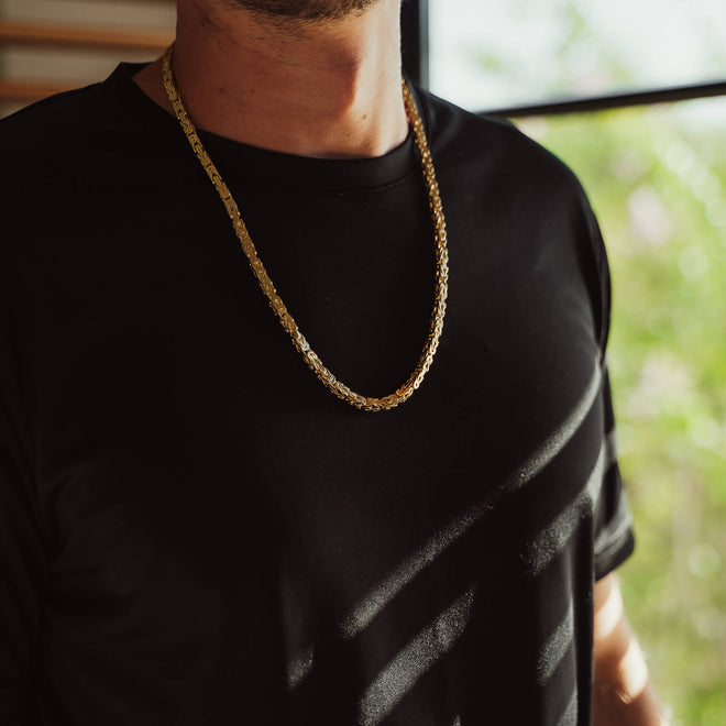 large gold byzantine chain on mans neck