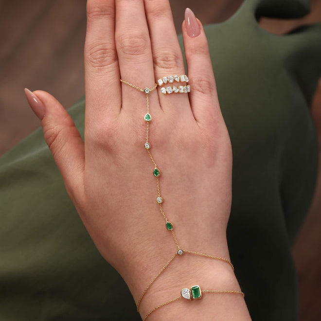 Emerald and Diamond Hand Chain in 14kt yellow gold worn on hand, natural emeralds and diamonds