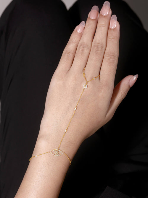 Evil Eye Diamond Hand Chain in 14kt yellow gold worn on hand, pavé evil eye natural diamonds