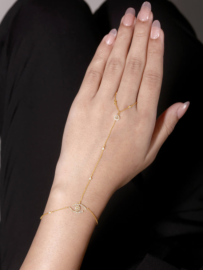 Evil Eye Diamond Hand Chain in 14kt yellow gold worn on hand, pavé evil eye natural diamonds