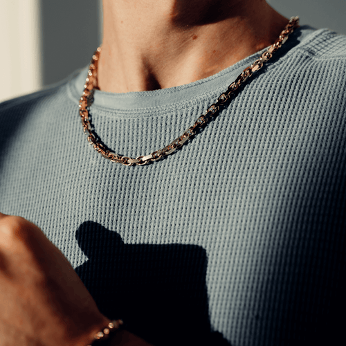 classic heavy link chain worn by man in green knit shirt